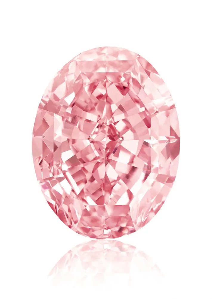 The Pink Star Diamond, a vivid pink oval-cut gemstone, displayed against a white background.