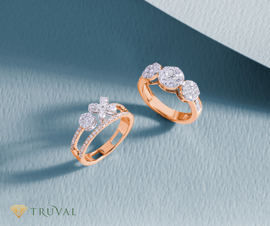 Elegant diamond rings on a soft blue background, featuring rose gold bands with round-cut diamonds, sold at Truval